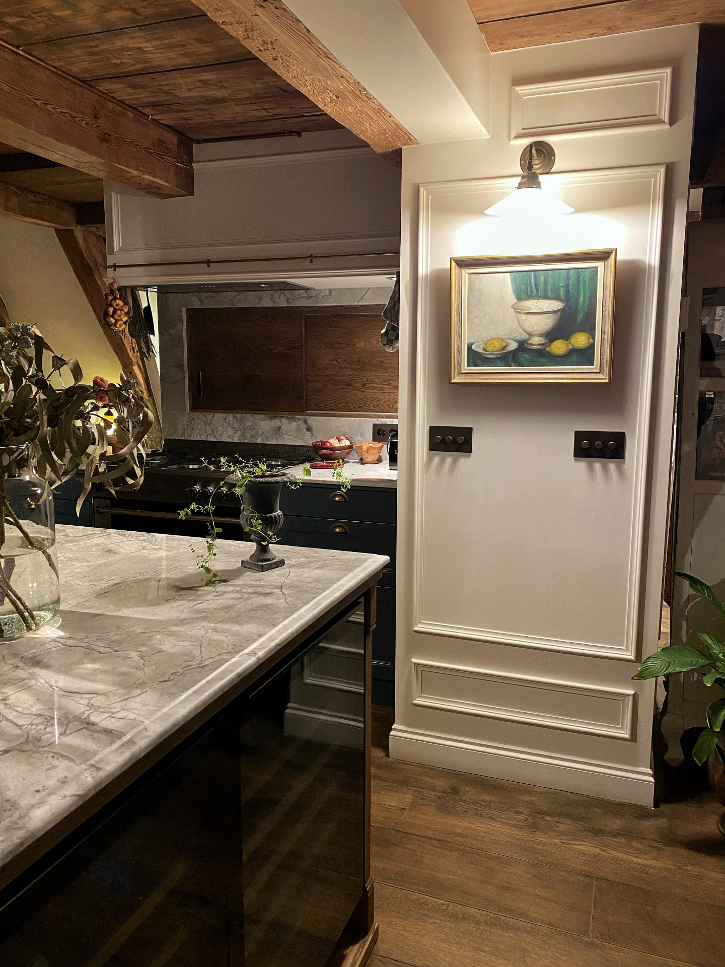 Curated kitchen with exposed beams and marble countertop